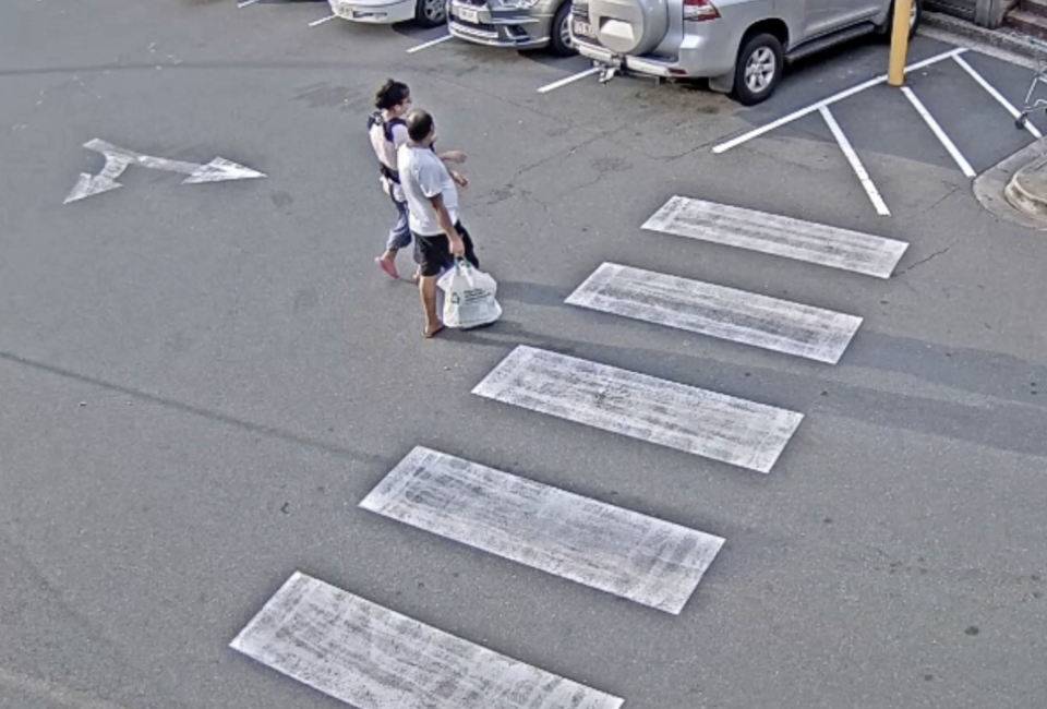 A woman, child and a man outside a Buranda shopping centre.