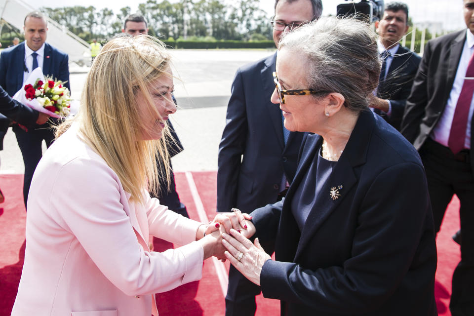 In this photo provided by the Tunisian Government, Tunisian Prime Minister Najla Bouden, right, welcomes Giorgia Meloni, Prime Minister of Italy, at Tunis Carthage airport, in Tunis, Sunday, June 11, 2023. Tunisia's increasingly autocratic president hosted the leaders of Italy, the Netherlands and the European Union on Sunday for talks aimed at smoothing the way for an international bailout and restoring stability to a country that has become a major source of migration to Europe. (Riadh Dridi/Tunisian Government via AP)