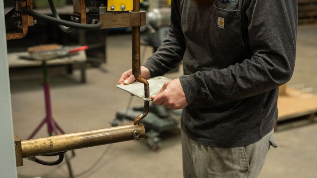 An employee works on the production floor at the Marlin Steel Wire Products factory in Baltimore, Maryland, US, on Thursday, March 14, 2024. 