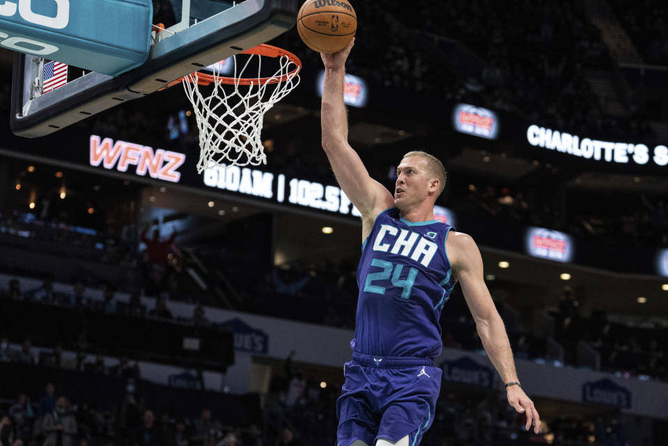 Charlotte Hornets center Mason Plumlee dunks the ball against the Cleveland Cavaliers during the first half of an NBA basketball game in Charlotte, N.C., Friday, Feb. 4, 2022. (AP Photo/Jacob Kupferman)