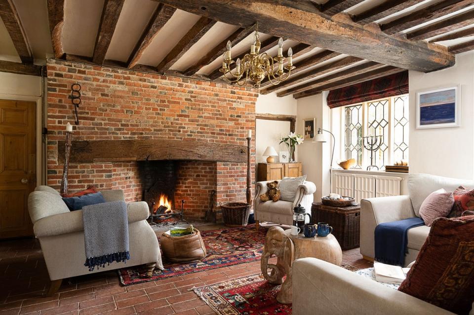 Wooden beams and a brick fireplace in one of six reception rooms (Kai Carter Estates)