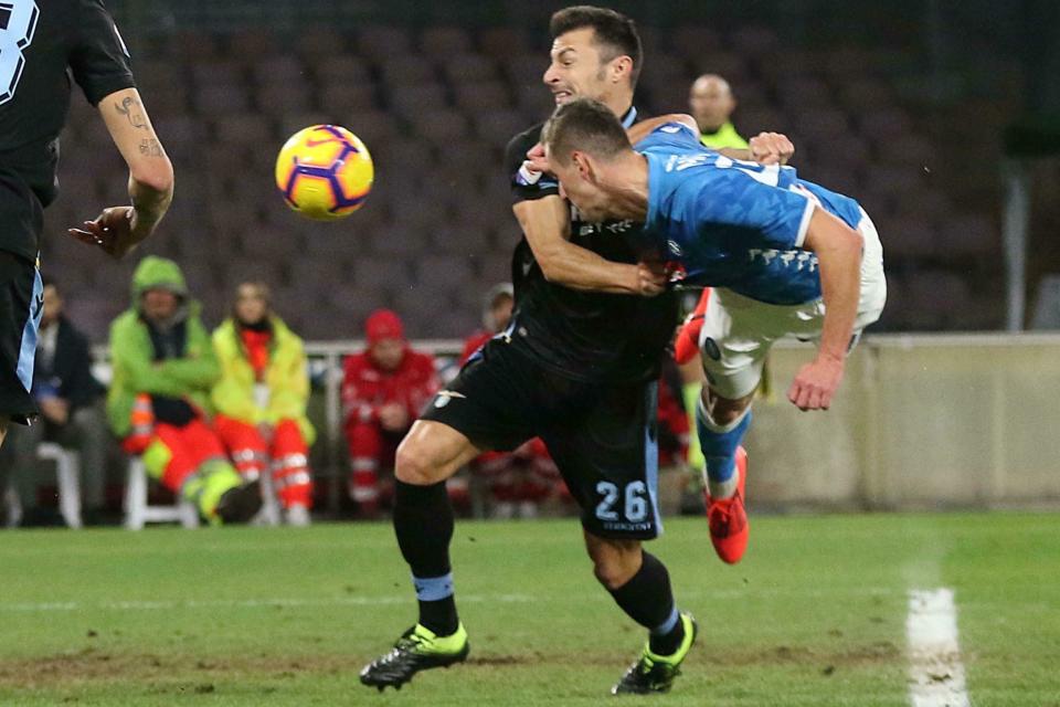 Lazio's defender Stefan Radu, left and Napoli's forward Arkadiusz Milik vie for the ball, during the Italian Serie A soccer match between SSc Napoli and SS Lazio at the San Paolo stadium in Naples, Sunday, Jan. 20, 2019. (Cesare Abbate/Ansa via AP)