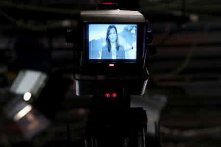 News anchor Maria Sarafoglou is seen at the display of a camera during a news broadcast at a studio of Greek private channel MEGA in Athens, Greece, August 30, 2016. REUTERS/Alkis Konstantinidis