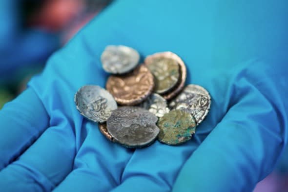 A precious hoard of Roman and Late Iron Age coins has been discovered in a British cave where they have lain undisturbed for more than 2,000 years