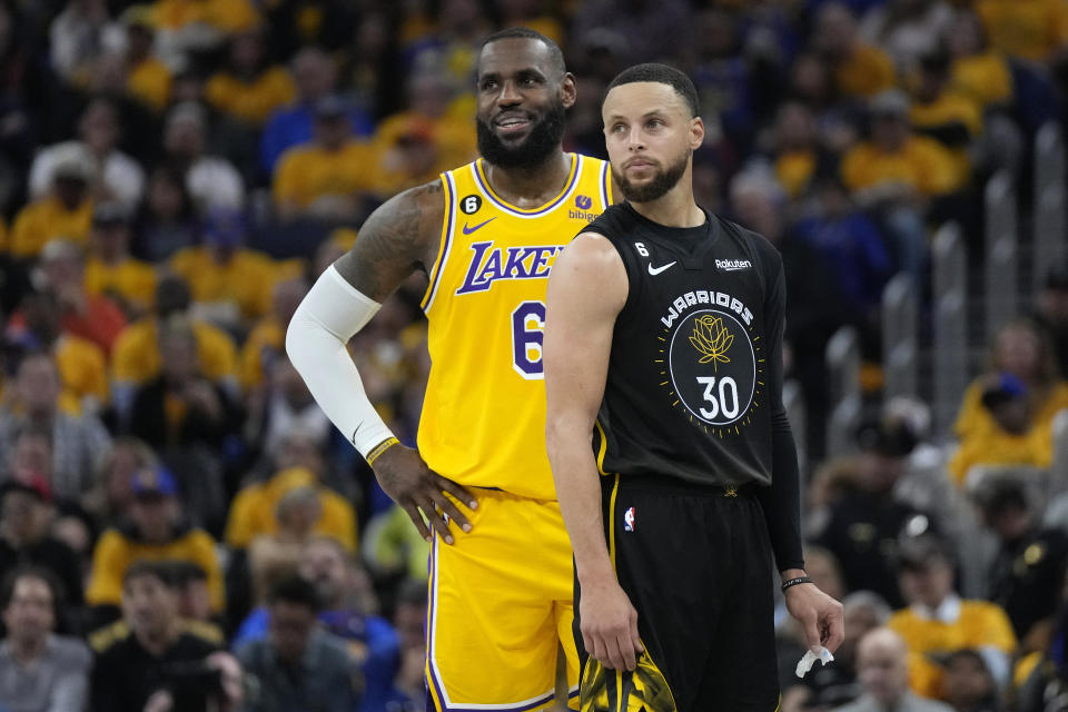 Los Angeles Lakers forward LeBron James (6) and Golden State Warriors guard Stephen Curry (30) stand together during the first half of their Western Conference semifinal series on May 2, 2023 in San Francisco.  (AP Photo/Jeff Chiu)