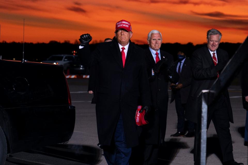 President Donald Trump and Vice President Mike Pence arrive for a campaign rally at Cherry Capital Airport, Monday, Nov. 2, 2020, in Traverse City, Mich. At right is White House chief of staff Mark Meadows. Meadows has since tested positive for COVID-19. (AP Photo/Evan Vucci)