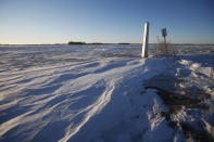A border marker, between the United States and Canada, is shown just outside of Emerson, Manitoba, on Thursday, Jan. 20, 2022. A Florida man was charged Thursday with human smuggling after the bodies of four people, including a baby and a teen, were found in Canada near the U.S. border, in what authorities believe was a failed crossing attempt during a freezing blizzard. The bodies were found Wednesday in the province of Manitoba just meters (yards) from the U.S. border near the community of Emerson. (John Woods/The Canadian Press via AP)