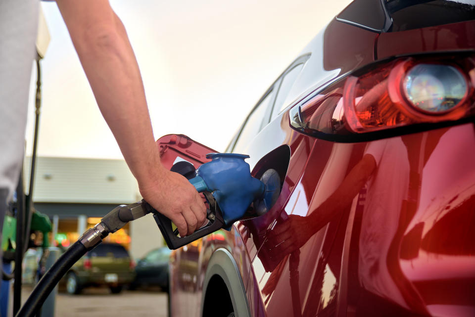 MONT-TREMBLANT, QUEBEC, CANADA, - SEPTEMBER 13, 2018: Male hand refuel a red car with gasoline at a gas station, close-up.