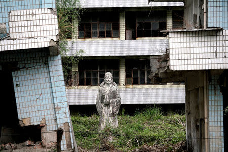 A statue stands at the site of a school destroyed in the 2008 Sichuan earthquake in the city of Beichuan, Sichuan province, China, April 4, 2018. REUTERS/Jason Lee