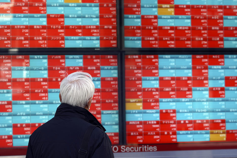 A person looks at an electronic stock board showing Japan's Nikkei 225 index at a securities firm Wednesday, Jan. 25, 2023, in Tokyo. Asian shares were mixed Wednesday after Wall Street indexes finished little changed as investors awaited earnings results from major global companies. (AP Photo/Eugene Hoshiko)
