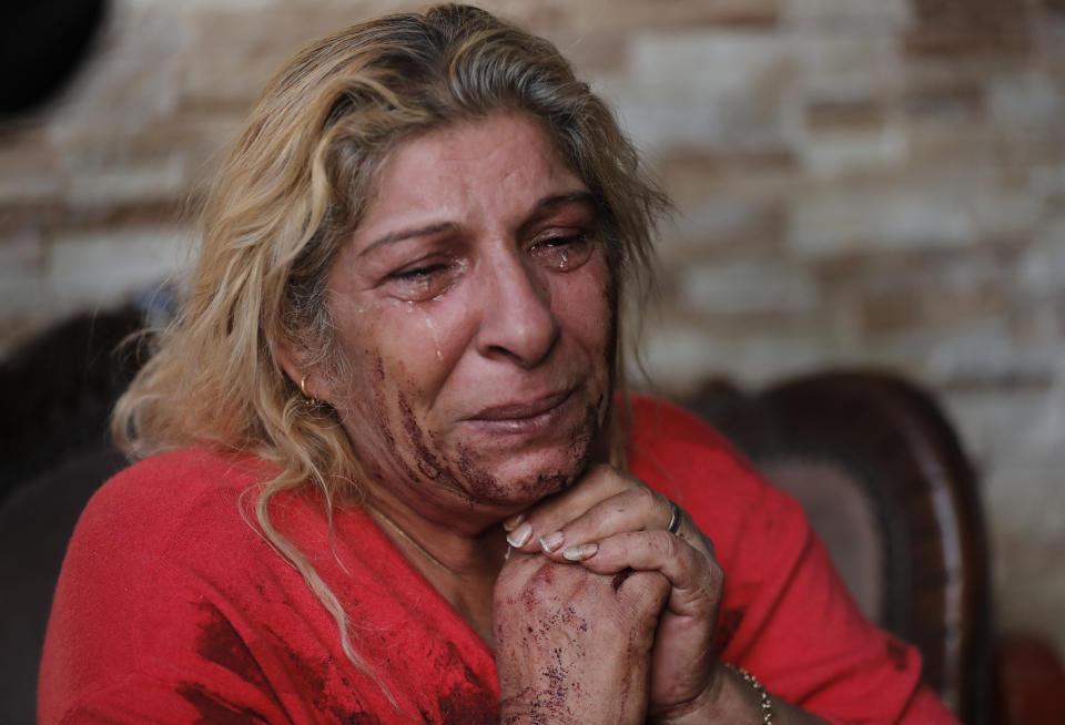 The mother of Danny Abi Haidar, 41, mourns her son who shot himself when he became despondent over salary cuts in recent weeks, according to his family, in Beirut, Lebanon, Wednesday, Dec. 4, 2019. The father of Danny said who worked in a lightning company, spent the day Tuesday warding off creditors, explaining that he only received half of his salary because of the economic crisis. Many private companies have resorted to reducing staff or slashing their pay to deal with the rising inflation and liquidity crunch. (AP Photo/Hussein Malla)