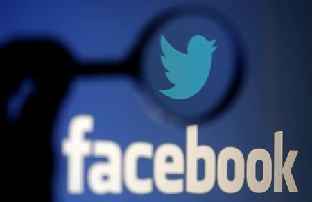 A logo of Twitter is pictured next to the logo of Facebook in this September 23, 2014 illustration photo in Sarajevo. REUTERS/Dado Ruvic