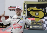 Justin Allgaier poses with his trophy in Victory Lane after winning the NASCAR Xfinity Series auto race at Darlington Raceway, Saturday, May 8, 2021, in Darlington, S.C. (AP Photo/Terry Renna)