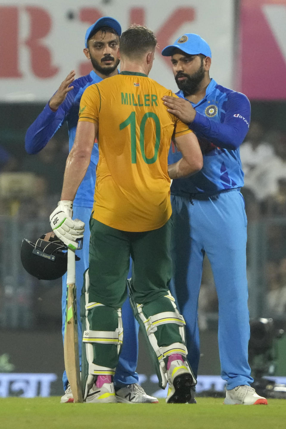 India's captain Rohit Sharma, right, congratulates South Africa's David Miller, center, on scoring a century during the second T20 cricket match between India and South Africa, in Guwahati, India, Sunday, Oct. 2, 2022. (AP Photo/Anupam Nath)