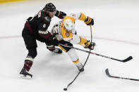 Nashville Predators' Viktor Arvidsson (33) and Arizona Coyotes' Jakob Chychrun (6) battle for the puck during first period NHL hockey action in Edmonton, Alberta, Friday, Aug. 7, 2020. (Jason Franson/The Canadian Press via AP)