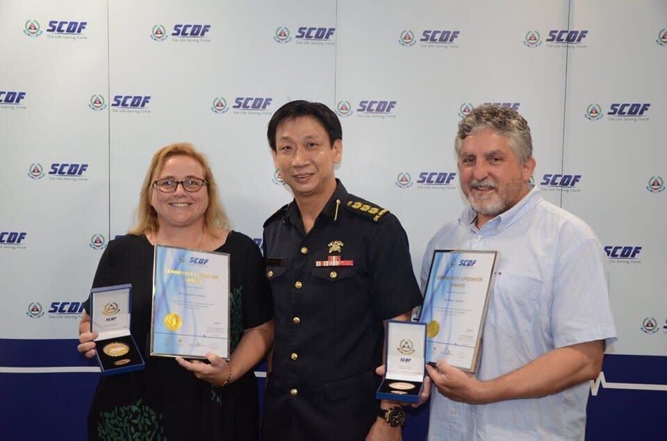 Mrs and Mr Valenta flanking Colonel Lim Boon Hwee (centre), commander of the 1st SCDF division on 3 May, 2019. (PHOTO: SCDF/Facebook)