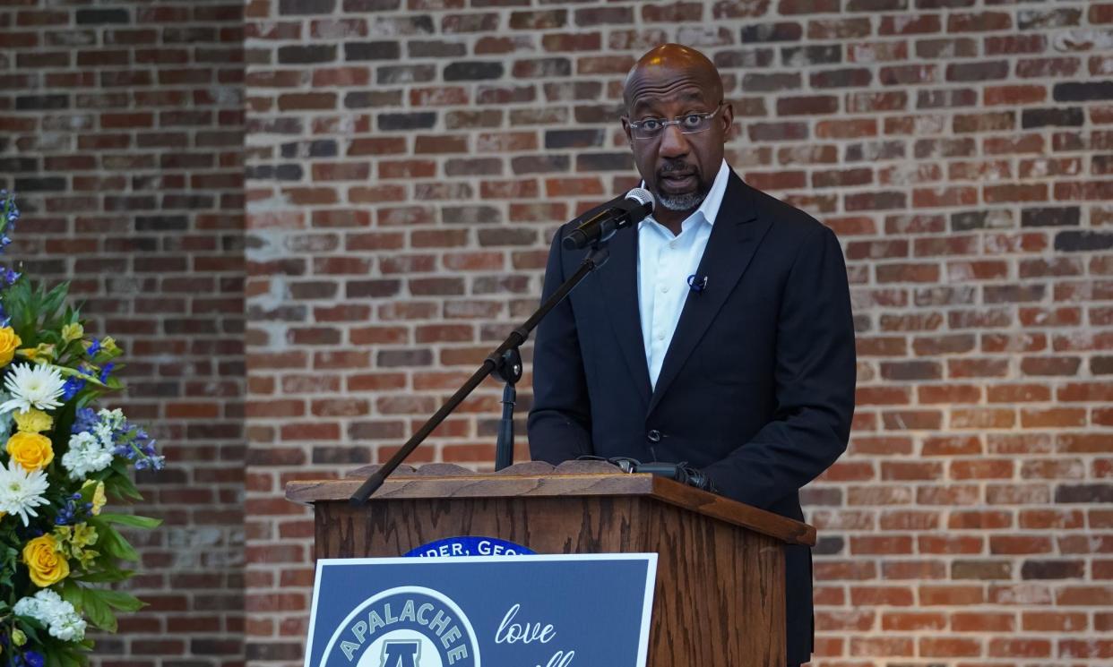 <span>Warnock speaks with community members, students, and faculty of Apalachee high school who came together for a vigil in Winder, Georgia, on Friday.</span><span>Photograph: Megan Varner/Getty Images</span>