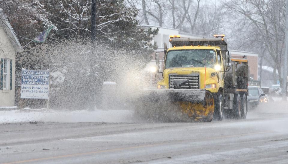 A Indiana Department of Transportation snow plow driver clears snow Tuesday, Jan. 9, 2024, along Lincoln Way East in Mishawaka.