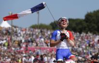 France's Julie Bresset celebrates after winning gold during the women's Cross-country mountain bike cycling event at Hadleigh Farm during the London 2012 Olympic Games, August 11, 2012. REUTERS/Cathal McNaughton (BRITAIN - Tags: SPORT CYCLING OLYMPICS TPX IMAGES OF THE DAY) 