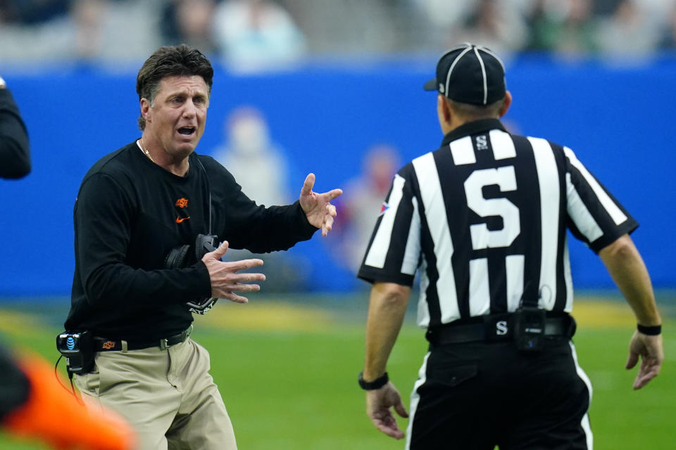 Oklahoma State head coach Mike Gundy argues a call with an official during the first half of the Fiesta Bowl NCAA college football game against Notre Dame, Saturday, Jan. 1, 2022, in Glendale, Ariz. (AP Photo/Ross D. Franklin)