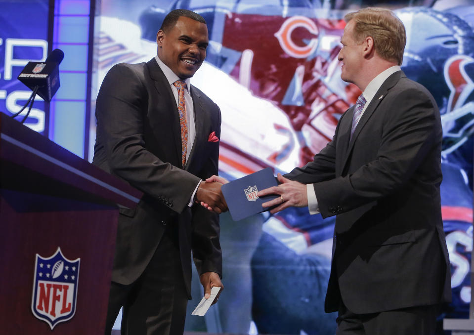 Former Houston Texans outside guard Chester Pitts, left, greets NFL commissioner Roger Goodell before announcing UCLA outside guard Xavier Su'a-Filo as theTexans' second pick in the second round of the 2014 NFL Draft, Friday, May 9, 2014, in New York. (AP Photo/Jason DeCrow)