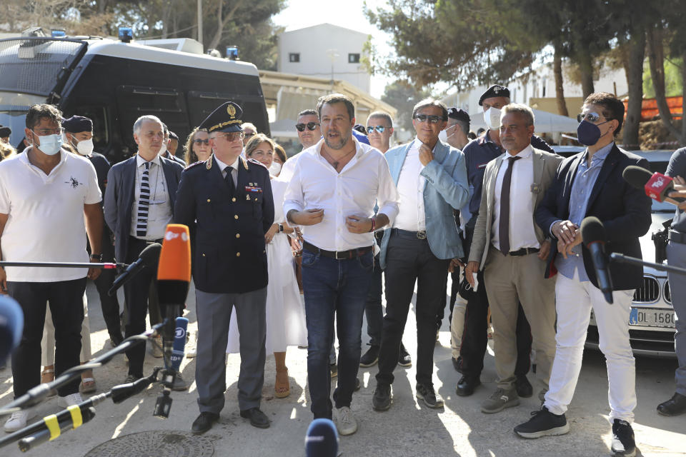 Italy's former Interior minister, Matteo Salvini and Leader of The League party, center, talks to journalists after visiting the migrant reception center in the Sicilian Island of Lampedusa, Italy, Thursday, Aug. 4, 2022. Salvini is making a stop Thursday on Italy's southernmost island of Lampedusa, the gateway to tens of thousands of migrants arriving in Italy each year across the perilous central Mediterranean Sea. (AP Photo/David Lohmueller)