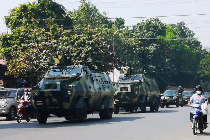 Myanmar Army armored vehicles drive past a street after they seized power in a coup in Mandalay