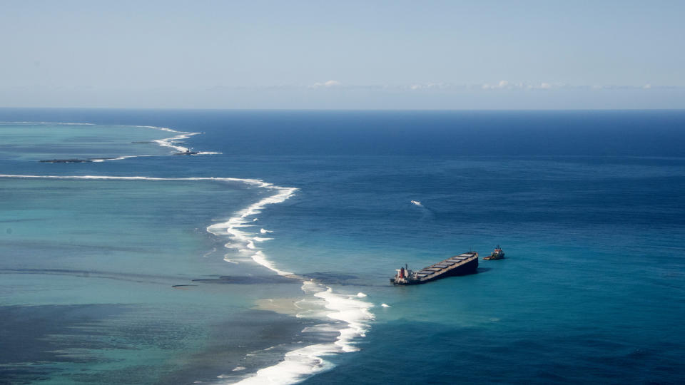 This photo provided by the French Army shows oil leaking from the MV Wakashio, a bulk carrier ship that ran aground off the southeast coast of Mauritius, Tuesday Aug.11, 2020. Thousands of students, environmental activists and residents of Mauritius were working around the clock trying to reduce the damage to the Indian Ocean island from an oil spill after a tanker ran aground on a coral reef. An estimated 1 ton of oil from the Japanese ship's cargo of 4 tons has already escaped into the sea, officials said. (Gwendoline Defente, EMAE via AP)