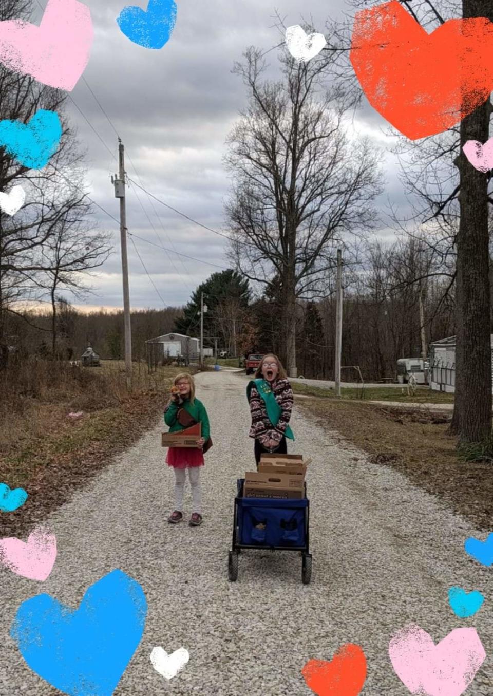 Sophia Schwab and Adelina Schwab, members of Girl Scout Troop 3723 in Greene County, walk their neighborhood doing door-to-door cookie sales.