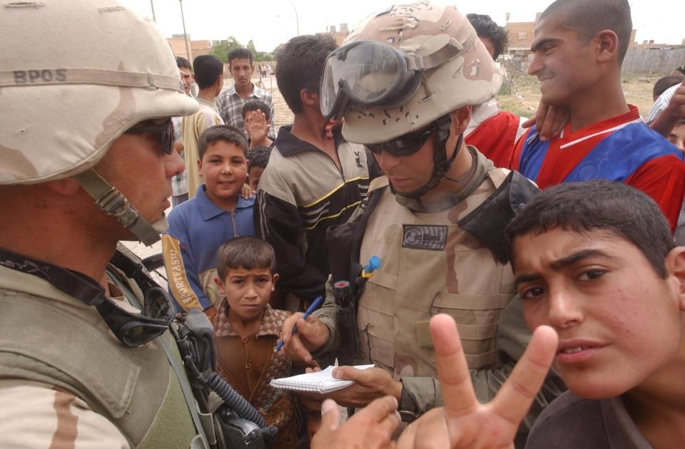 Reporter John Diedrich interviews a soldier from the 3rd Armored Cavalry Regiment on patrole in Ramadi, Iraq, in May 2003. Diedrich was working for the Colorado Springs Gazette at the time. He was embedded with the 3rd ACR during the invasion of Iraq.