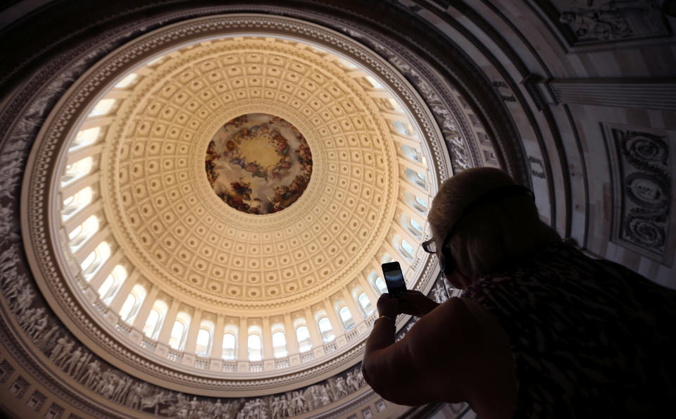 A man takes a photo of the U.S. Capitol Dome in the Rotunda, which reopened today following the successful completion of its restoration, in Washington, U.S., September 6, 2016. REUTERS/Kevin Lamarque