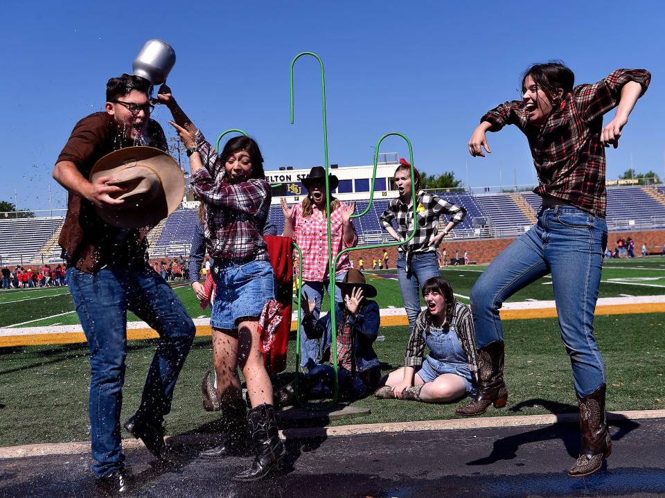 Cameron Flores dumps a pitcher of water over the head of fellow theater student Cody Free as Cameron Wisener jumps in the air at Hardin-Simmons University during a performance for school children at Western Heritage Day in April 2019. HSU has achieved its goal to become a Hispanic Serving Institution at 25% of enrollment.