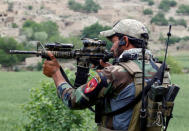 A member of Afghanistan's special forces point his gun as he observes the enemy lines in Achin district of Nangarhar province in eastern Afghanistan April 23, 2017. REUTERS/Parwiz