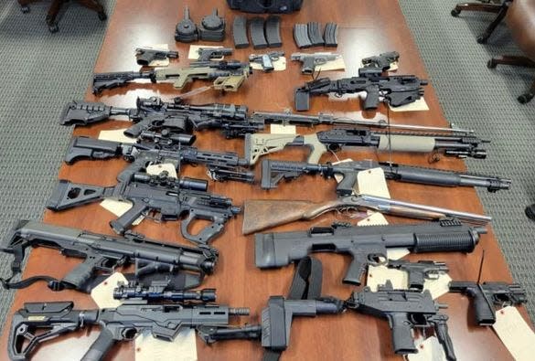 Federal authorities and the Portage County Sheriff's Office seized 20 firearms, about 5,000 rounds of ammunition and numerous high-capacity magazines while executing a federal search warrant at a Ravenna Township residence Friday.