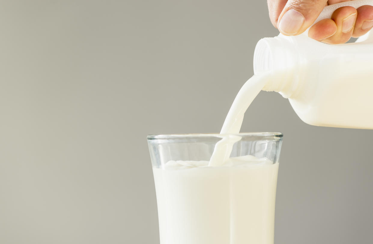 Hand pouring milk