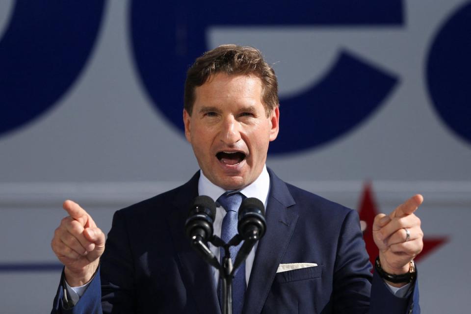 Dean Phillips speaks after filing the paperwork to put his name on the ballot for the state’s primary election outside the statehouse in Concord, New Hampshire (REUTERS)