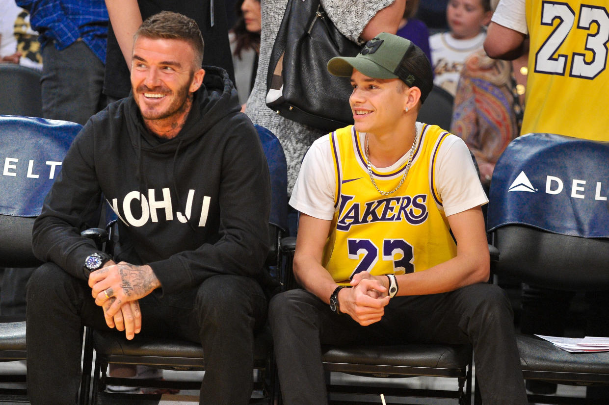 LOS ANGELES, CALIFORNIA - OCTOBER 27: (L-R) David Beckham and his son Romeo Beckham attend a basketball game between the Los Angeles Lakers and the Charlotte Hornets at Staples Center on October 27, 2019 in Los Angeles, California. (Photo by Allen Berezovsky/Getty Images)