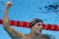 Caeleb Dressel, of United States, celebrates winning the gold medal the men's 50-meter freestyle final at the 2020 Summer Olympics, Sunday, Aug. 1, 2021, in Tokyo, Japan. (AP Photo/Jae C. Hong)