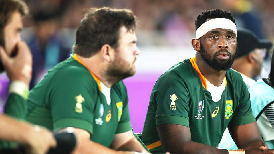 Siya Kolisi (pictured right) looks on from the bench during the Rugby World Cup 2019 Final.