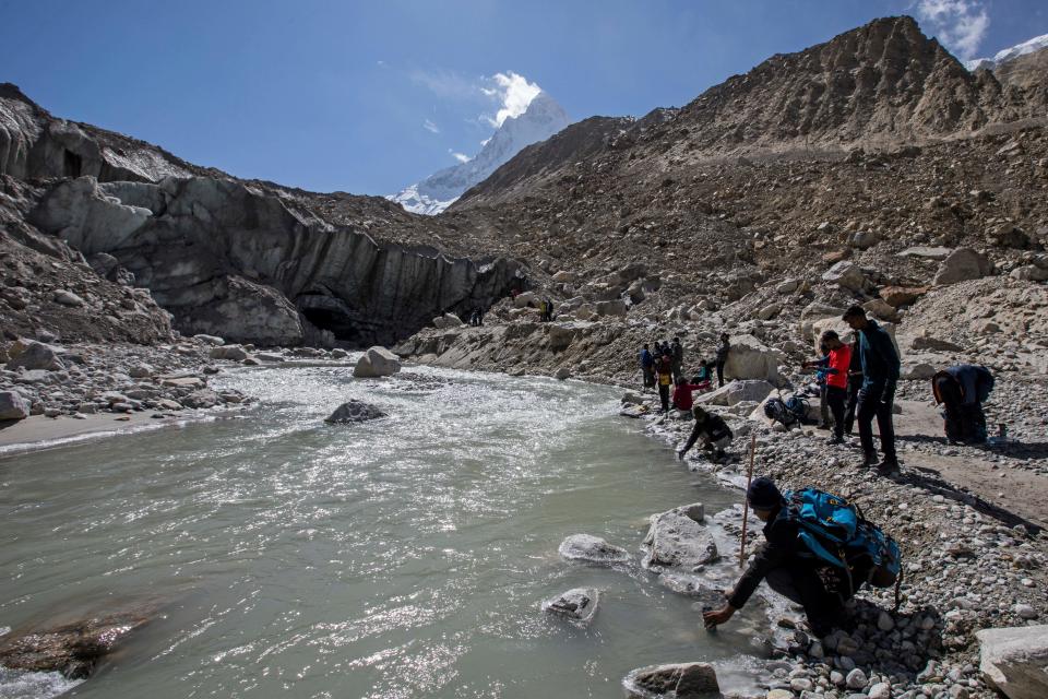 Trekkers collect water near the Gaumukh, (