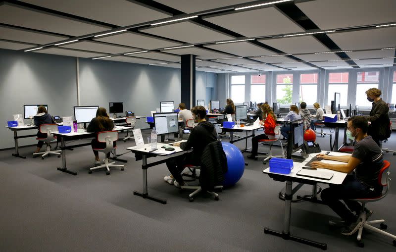 FILE PHOTO: Employees work at the center for contact tracing of the Canton of Zurich in Pfaeffikon