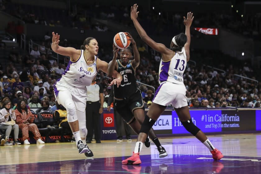 LOS ANGELES, CALIFORNIA - JULY 03: Natasha Howard #6 of the New York Liberty handles the ball defended by Liz Cambage #1 and Chiney Ogwumike #13 of the Los Angeles Sparks in the second half at Crypto.com Arena on July 03, 2022 in Los Angeles, California. NOTE TO USER: User expressly acknowledges and agrees that, by downloading and or using this photograph, User is consenting to the terms and conditions of the Getty Images License Agreement. (Photo by Meg Oliphant/Getty Images)