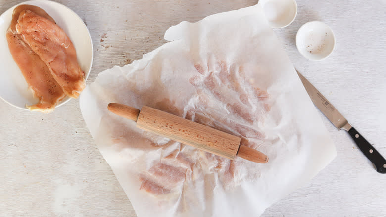 rolling pin flattening chicken breast