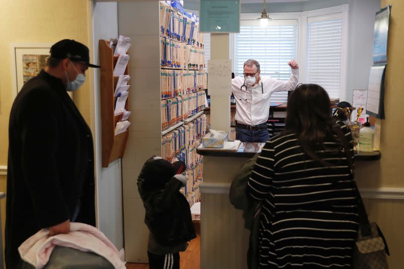 Dr Greg Gulbransen gestures to a toddler after a checkup for his daughter while maintaining visits with both his regular patients and those confirmed to have the coronavirus disease (COVID-19) at his pediatric practice in Oyster Bay, New York