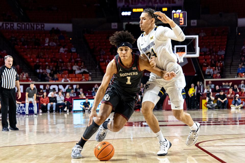 Oklahoma forward Jalen Hill (1) works past West Virginia forward Patrick Suemnick (24) in the first half during a college basketball game between the Oklahoma Sooners (OU) and the West Virginia Mountaineers at Lloyd Noble Center in Norman, Okla., Saturday, Jan. 14, 2023.