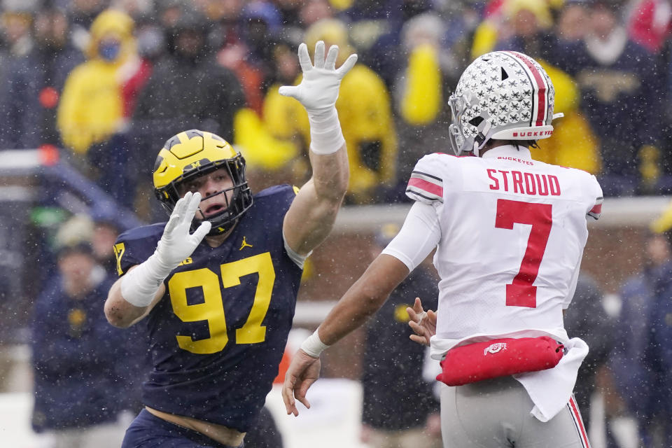 Michigan defensive end Aidan Hutchinson (97) rushes Ohio State quarterback C.J. Stroud (7) during the first half of an NCAA college football game, Saturday, Nov. 27, 2021, in Ann Arbor, Mich. Michigan coach Jim Harbaugh said star defensive end Aidan Hutchinson should be strongly considered for the Heisman Trophy after he had three sacks, setting a single-season record for college football team, in a win over Ohio State that put the Wolverines in the Big Ten championship game and national title race. (AP Photo/Carlos Osorio)