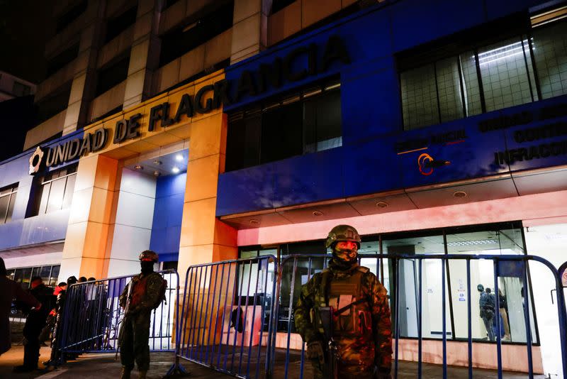 Police and military officials stand outside the Flagrancy Unit, where former Ecuador Vice President Jorge Glas is believed to be detained, in Quito