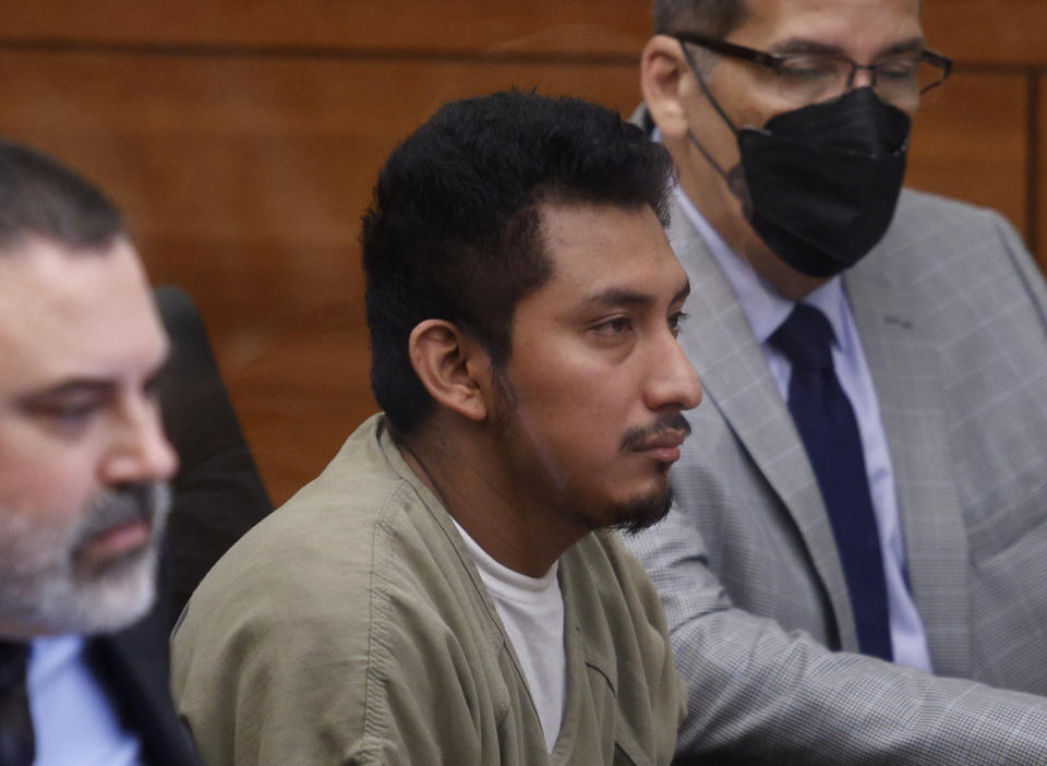 Gerson Fuentes, center, the man accused of raping a 10-year-old girl who then traveled to Indiana to have an abortion, center, appears between his lawyer, Bryan Bowen, left, and an interpreter in Franklin County common pleas court for his bond hearing in Columbus, Ohio, Thursday, July 28, 2022. Judge Julie Lynch denied bond. (AP Photo/Paul Vernon)