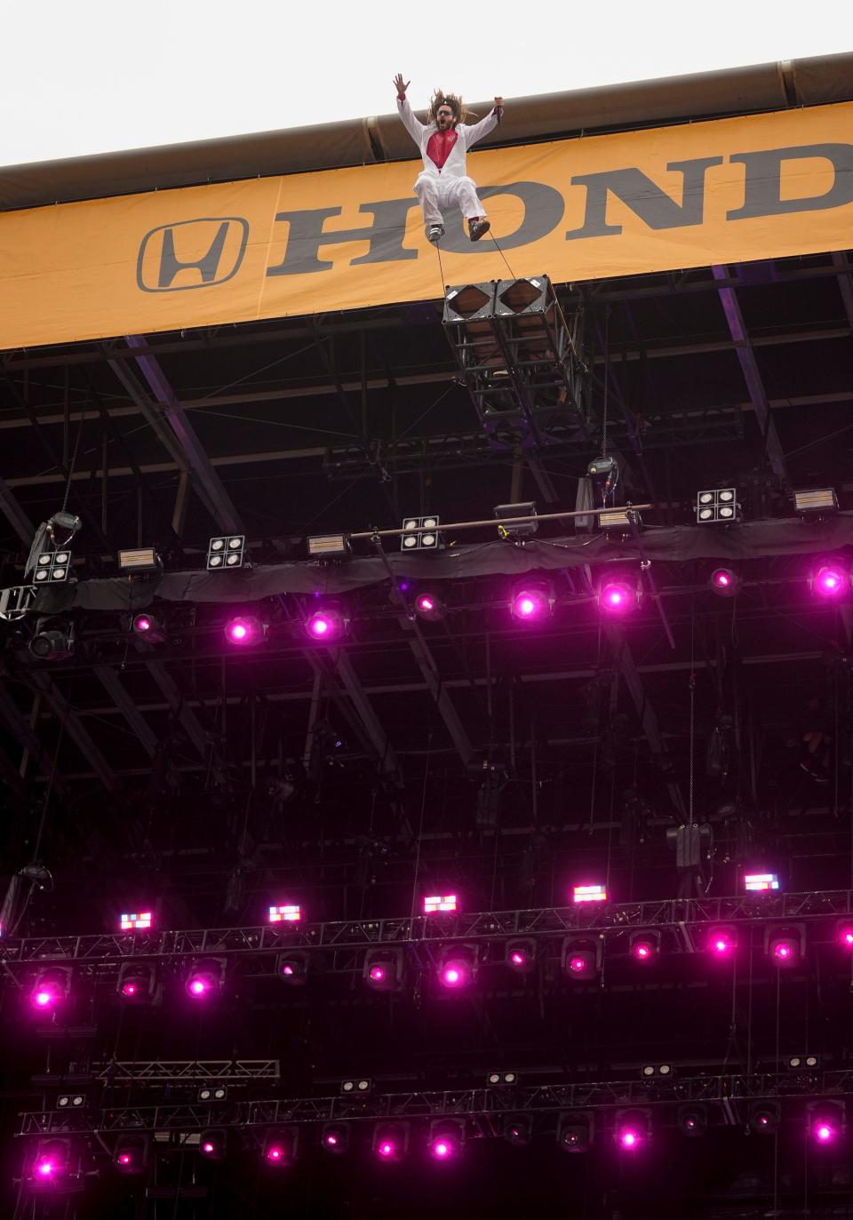 Jared Leto of Thirty Seconds to Mars jumps with a tether from the top of the Honda Stage on Saturday at the Austin City Limits Music Festival.