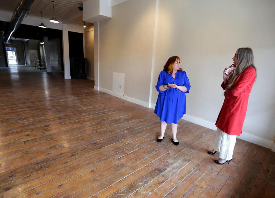 Kim Massey of Wisconsin Women’s Business Initiative Corporation, right, and loan client Angela Green-Ludvik, owner of Nectar Hair Lounge tour her newly leased space Friday in Menasha.